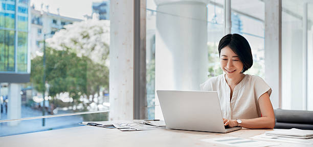 istock Middle-aged woman using computer technology for financial marketing work online. Mature Asian professional businesswoman analyst working concentrated on laptop pc at desk in office. Banner, copy space 2227434519