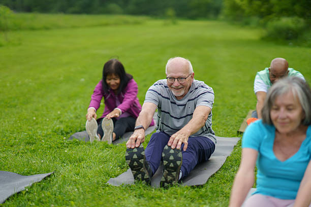 istock Active Seniors Enjoying Group Exercise Outdoors at a Scenic Park 2227440964