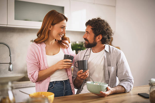 istock Happy couple enjoying coffee and breakfast in modern kitchen 2227440984