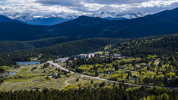 istock Highway cuts through wilderness valley with snow-capped peaks beyond. Rural infrastructure connects communities in Gilpin County, Colorado. 2227443284
