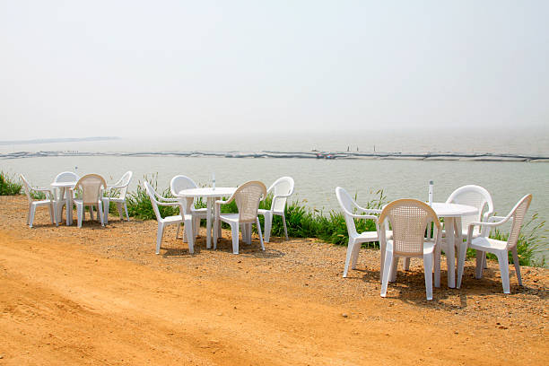 White plastic tables and chairs on the dam