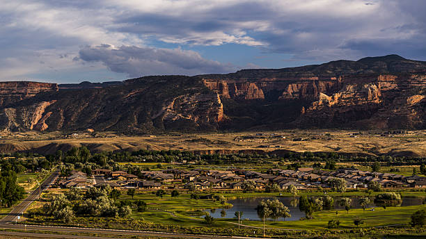 istock Rural community nestled beneath dramatic cliffs. Residential development in Fruita, Colorado valley with mountain backdrop. 2227445251