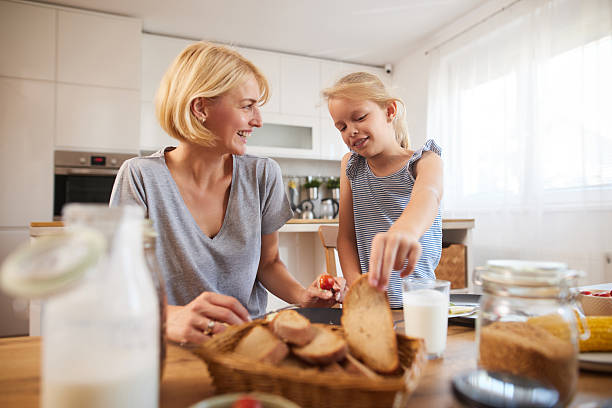 istock Family bonding during breakfast preparation in a cozy kitchen on a sunny morning 2227445429