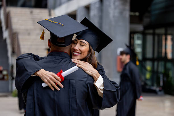 istock Happy post-graduate students hugging while celebrating their graduation 2227445679