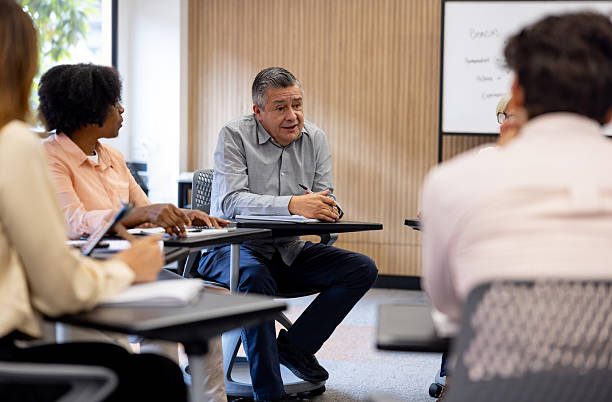 istock Mature university student talking to a group in a debate 2227445712