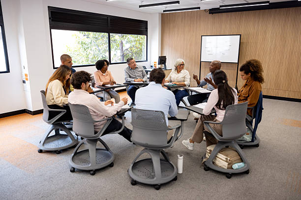 istock Group of multigeneration students talking in a debate at the university 2227445761