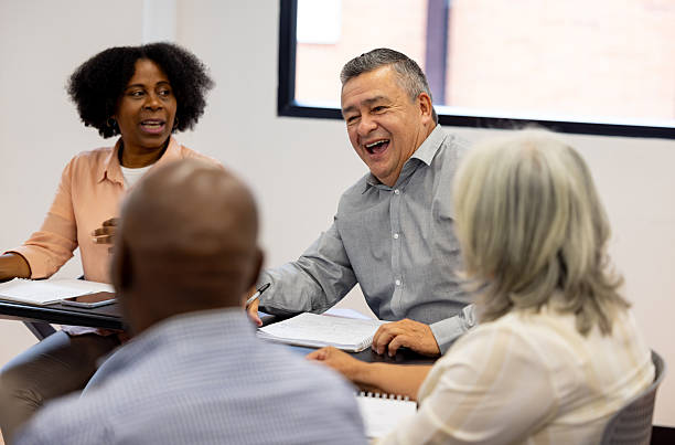 istock Mature man going back to school and laughing in class while having a debate 2227445775