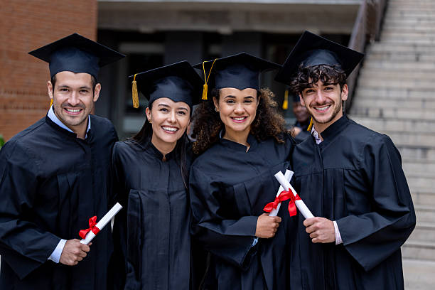 istock Happy group of students smiling on their graduation while holding their diplomas 2227445821