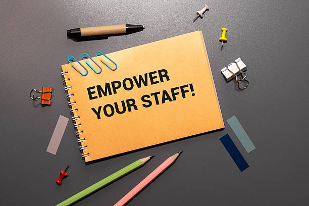 istock calculator and a notepad with EMPOWER YOUR STAFF text. 2227445862