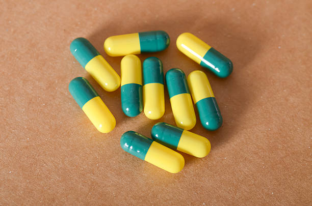 Closeup of vitamins and supplements capsule pills in blister packaging. Pharmaceutical industry concept. Full frame capsule pills background. Global pharmaceuticals. Defective concept.