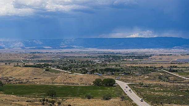 istock Thunderstorm approaches rural town. Rain falls over mountains in Carbon County, Utah. 2227447499