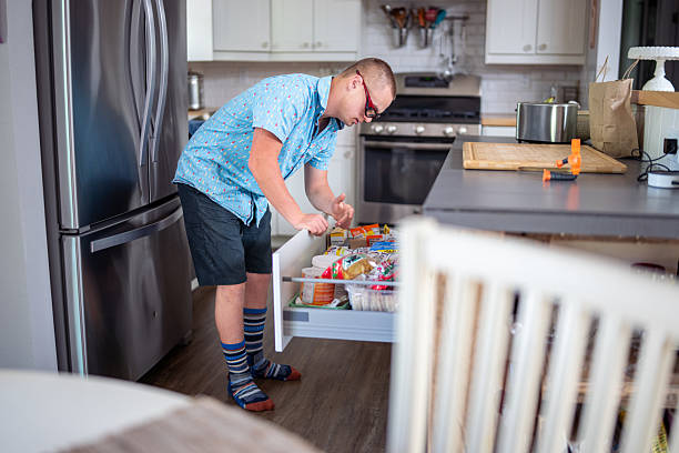 istock Teenager looking for snack in kitchen 2227451044