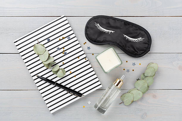 istock Sleeping mask with accessories on wooden background, top view. Sleeping routine concept 2227451081