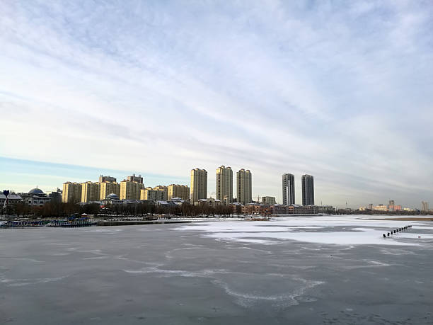 drone point of view Jilin, Jilin province cityscape in morning sunrise at riverbank