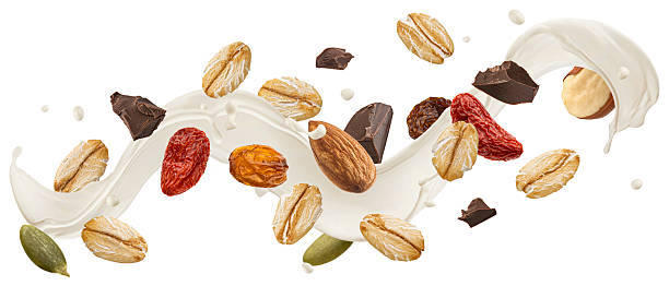 istock Falling muesli with milk splash isolated on white background 2227456365