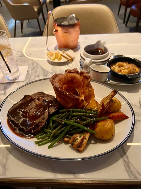 istock English roast beef Sunday roast with gravy and Yorkshire pudding 2227459375
