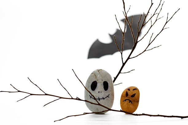 istock Creative Halloween Decorations With Painted Stones and Twigs Set Against a White Background 2227459766