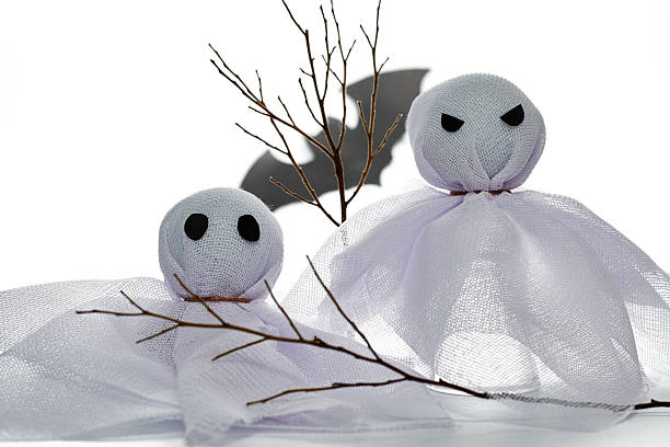 istock Ghost Decorations With Eerie Shadows Created by Branches During Halloween Season 2227459795
