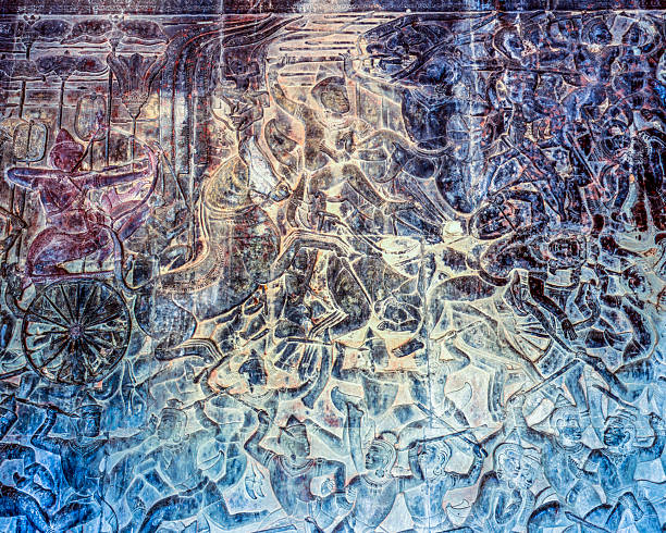 Ornate stone carvings showcasing figures in traditional attire, photographed at Angkor Wat Temple in Cambodia, highlighting the region's rich cultural heritage and ancient architectural artistry.