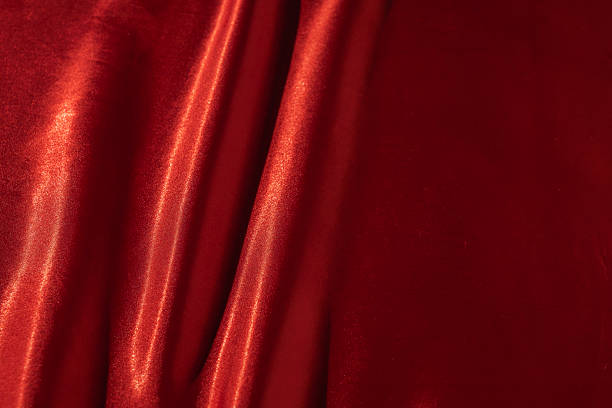 istock Red satin silk with crumpled abstract texture background. Material textile surface. Copy space 2227468312