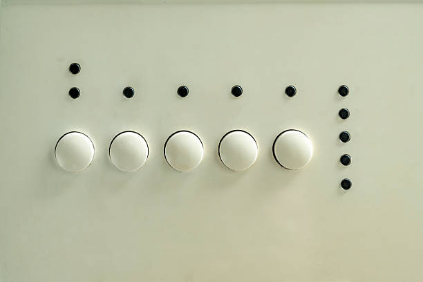 Close-up of sleek white and silver light switches on textured wall. Minimalist home decor. Essential electrical accessories for modern interiors.