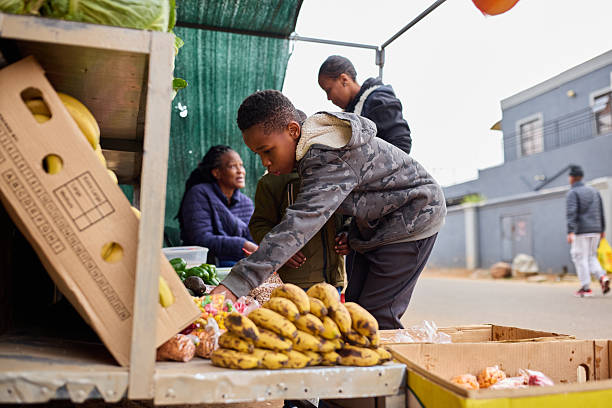 People are selling food at an intercity bus stop in Angola