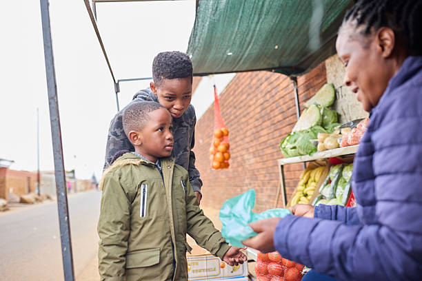 istock Brothers talking with vendor while shopping 2227478968