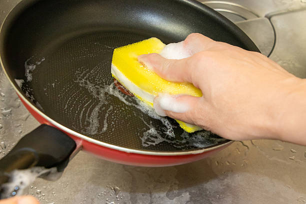 istock Wash the pan with a kitchen sponge 2227480285