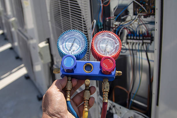 istock Air conditioning, HVAC service technician using gauges to check refrigerant and add refrigerant. 2227481703