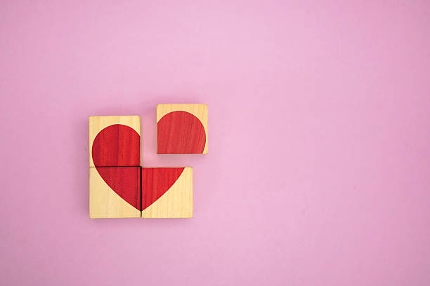 istock Broken Heart Puzzle Concept on Wooden Blocks 2227482525