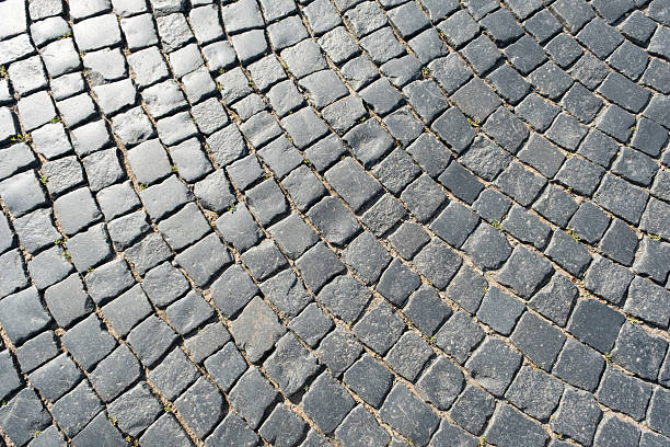 istock Cobblestone pavement pattern in a historic street showing intricate design during bright daylight 2227483247