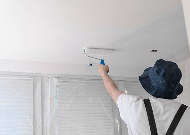 istock A house painter painting the kitchen ceiling white, renovation 2227488189