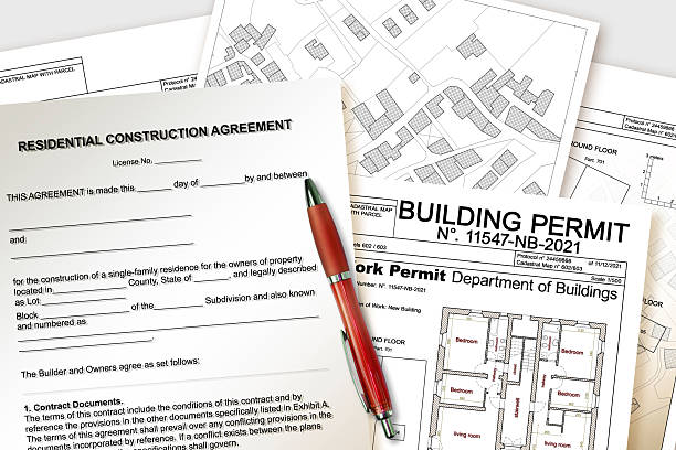 istock RESIDENTIAL CONSTRUCTION AGREEMENT FORM WITH LEGAL TEXT - Concept with building permit of residential building project, cadastral map, ideal for real estate, legal, or construction themes 2227489012