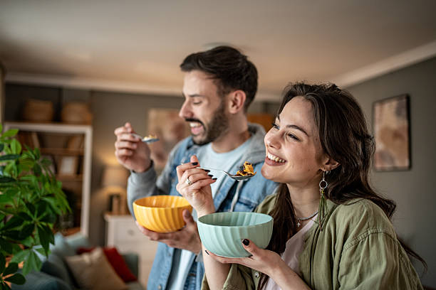 istock Happy couple enjoying breakfast cereal at home 2227489410
