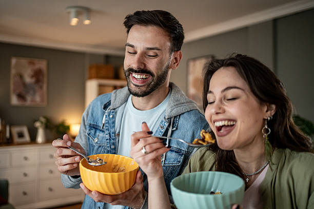 istock Cheerful couple enjoying breakfast together at home 2227489416