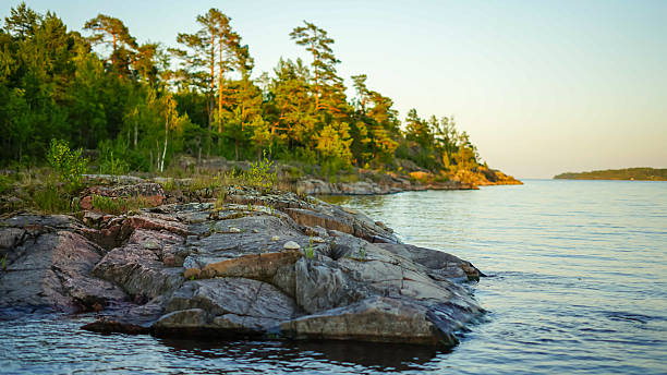 istock Rocky shoreline with trees and a calm lake 2227491770