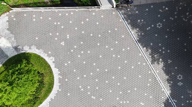 istock Modern concrete paving stones with decorative pattern and green island 2227493750