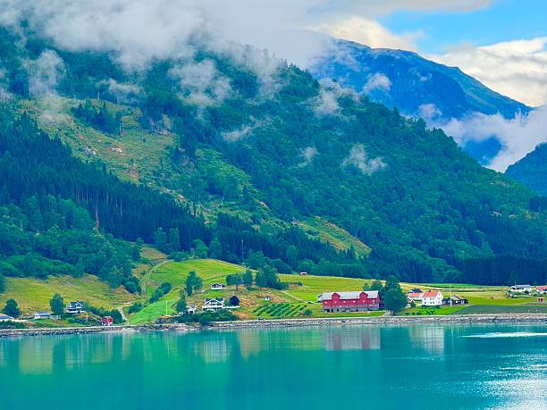 Beautiful Norwegian houses between Aurlandsfjord and mountains in Aurland, Norway