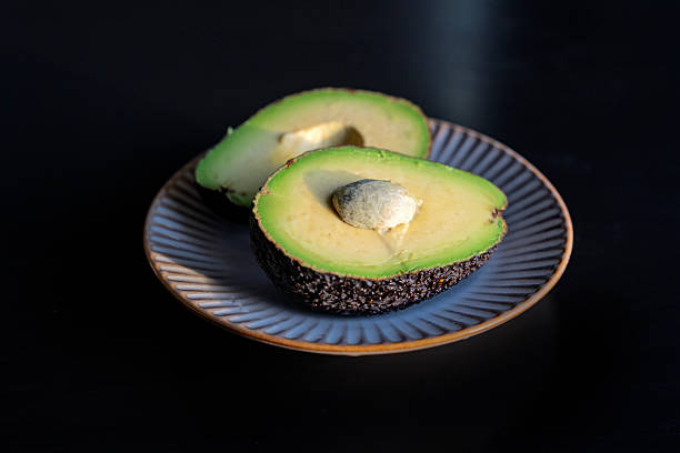 Fresh Ripe Avocado Halves on Ceramic Plate