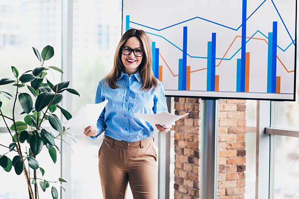 istock Confident businesswoman presenting data analysis charts in a modern corporate office space 2227496063