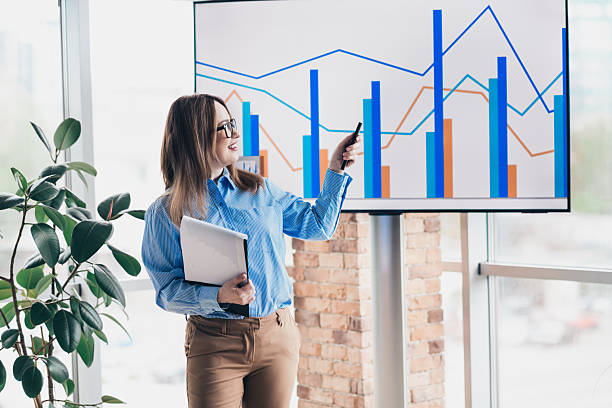 istock Young businesswoman presenting data on analytics charts in a professional meeting in a modern executive office 2227496064