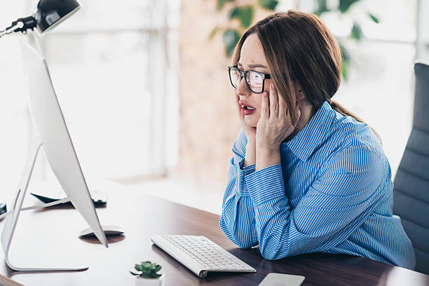 istock Young businesswoman looking distressed while working at her desktop computer in a modern office environment 2227496301