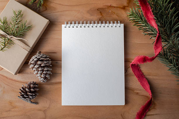 istock Blank Notepad with Pinecones, Red Ribbon, and Holiday Gift Box 2227496314