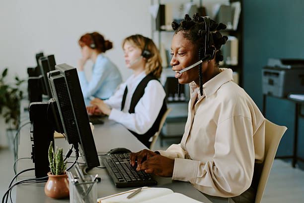 istock Collaborating in Customer Service Call Center with Headsets 2227496795