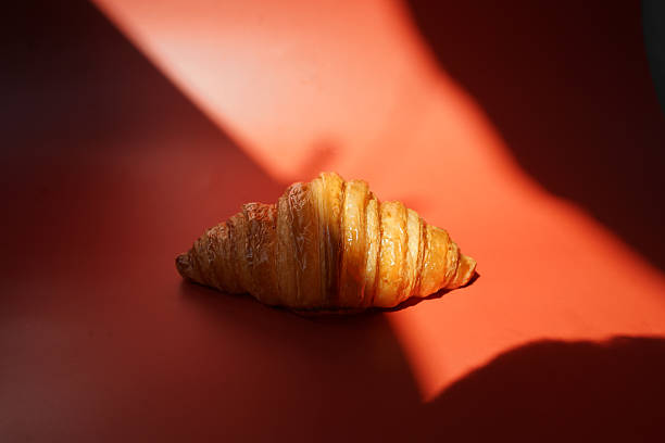 istock Close up plain butter croissant on red background 2227497521