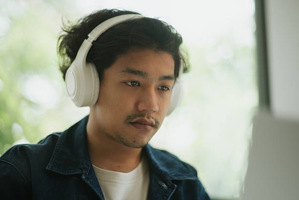 istock Asian man doing online learning at home. 2227500379