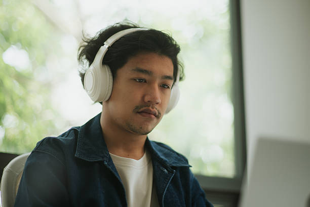 istock Asian man doing online learning at home. 2227500380