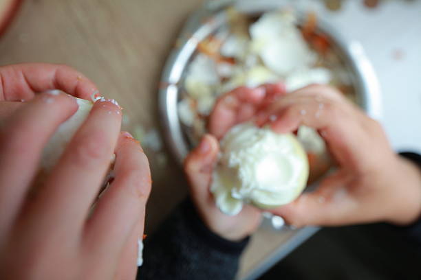 istock two child's hands cutting vegetables for salad close up 2227500593