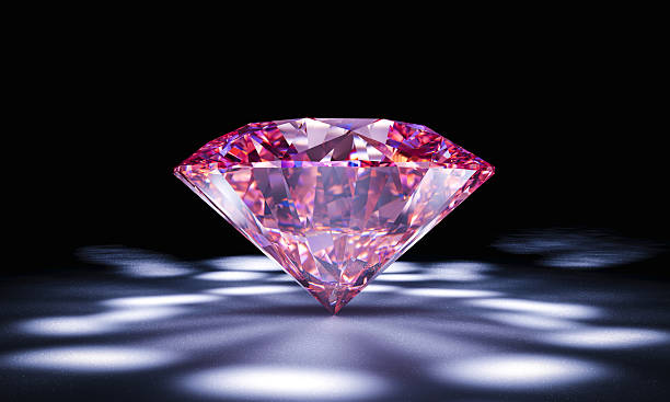 istock Sparkling pink diamond on black background with dramatic lighting 2227500970