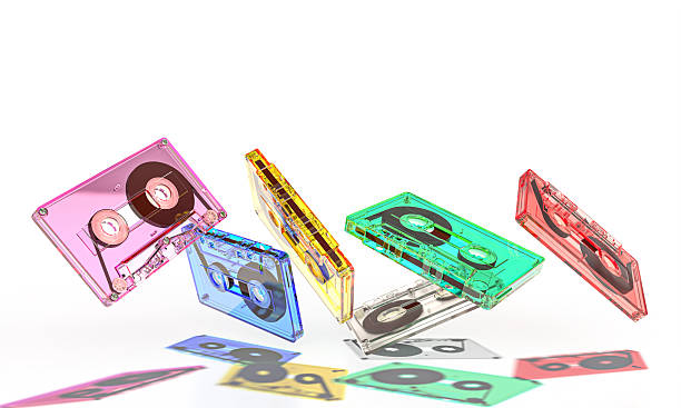 Colorful audio cassettes falling on white background
